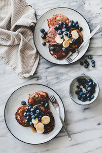 Healthy breakfast with banana pancakes with bluelerry and honey