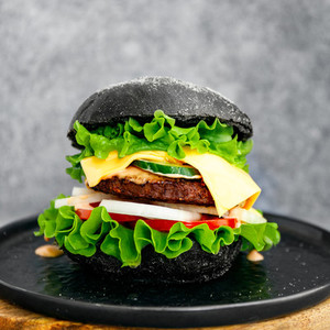 Big black burger with marble beef patty  cheese and fresh vegetables