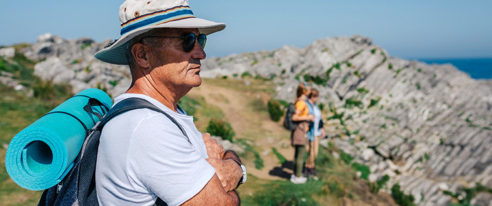 Senior man trekking looking at the landscape