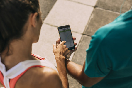 Runners using a fitness app to monitor their performance