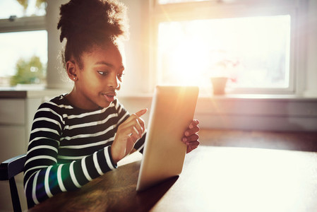 Afro American Girl Surfing Internet Using Tablet