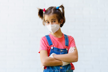 Child girl wearing a protection mask against coronavirus during Covid 19 pandemic