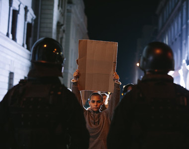 Demonstrators protesting in front of policemen