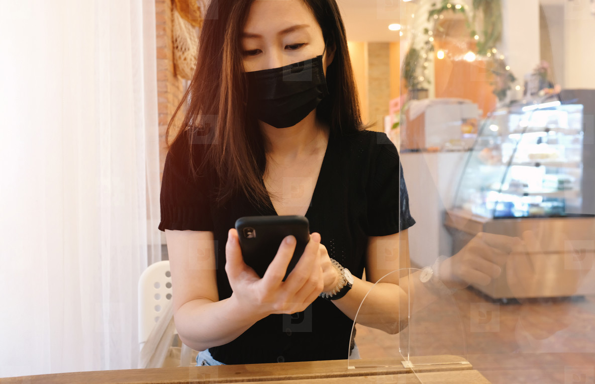 Young asian woman sitting separated in restaurant or cafe and us