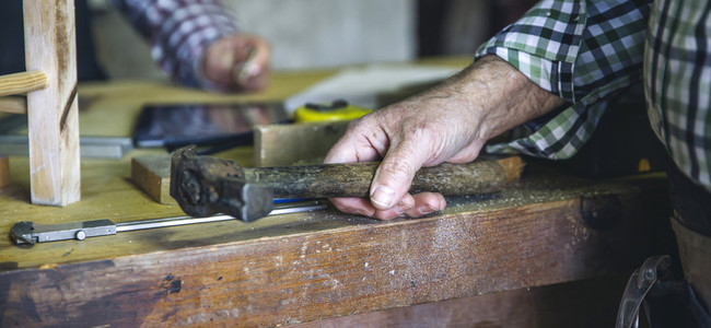 Carpenters hand holding a hammer