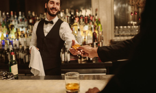 Barman accepting cashless payment