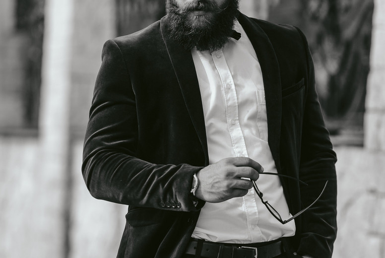 A rich man with a beard, thinking about business