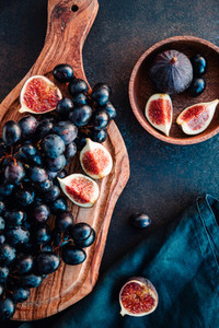 Autumn food still life with blue grape and ripe figs