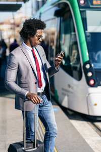 Black Businessman wearing suit waiting his train