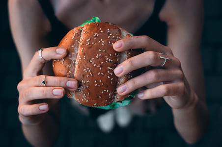 Hand hold a burger