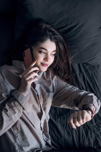 girl wake up with telephone and watches