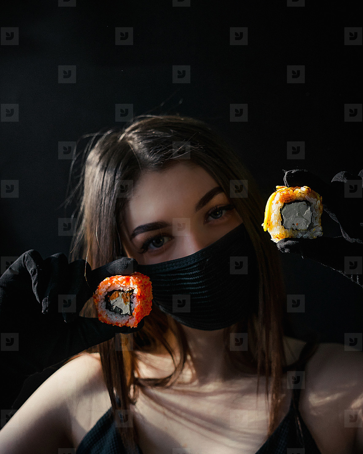 Masked girl holds sushi