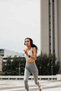 Fitness woman running in the city
