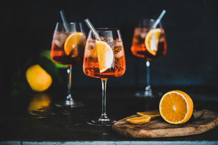 Aperol Spritz cocktail in glass with fresh oranges  black background