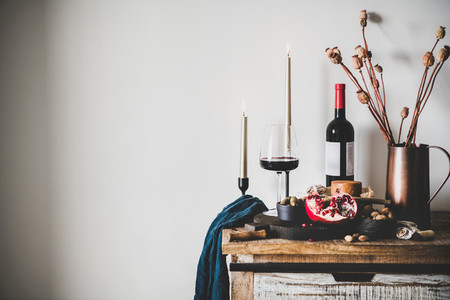 Red wine and snack set over kitchen counter  copy space