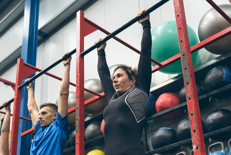 Athletes ready to do pull ups in the box