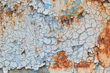 Background of peeling blue paint on an iron wall