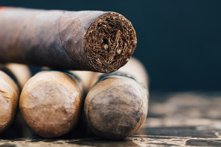 Close up of Cuban cigars on brown marble  Macro shot