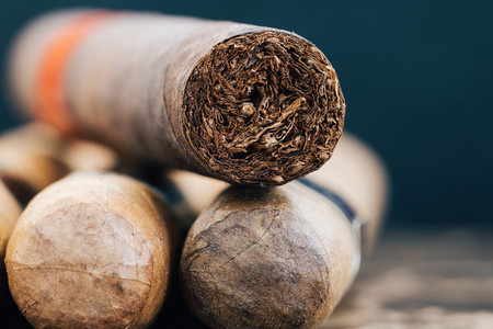 Close up of Cuban cigars on brown marble Macro shot
