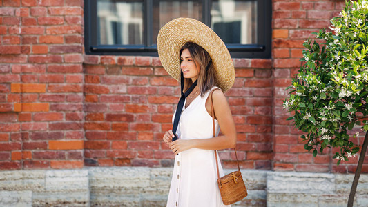 Stylish woman wearing straw hat