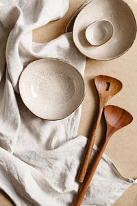 Modern minimalist ceramics set over a linen cloth Natural products or food concept top view flat lay
