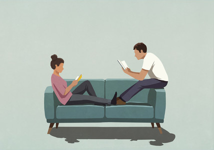 Couple reading books on sofa