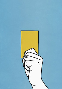 Hand holding yellow card
