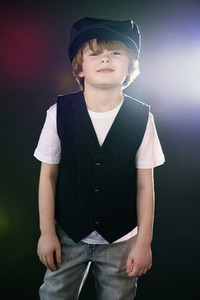 Portrait confident cool boy in cap and vest