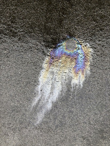 Colorful oil spill on wet pavement
