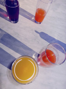 Variety of fruit juices in glasses on table