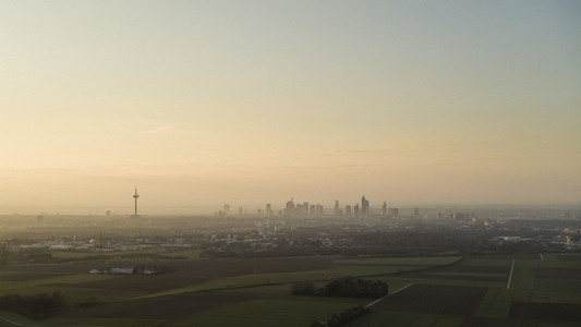 Sunset over Frankfurt skyline and rural farmland