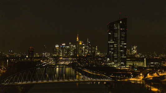 Illuminated cityscape along river at night