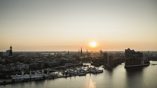 Sunset over tranquil Hamburg cityscape and Elbe River