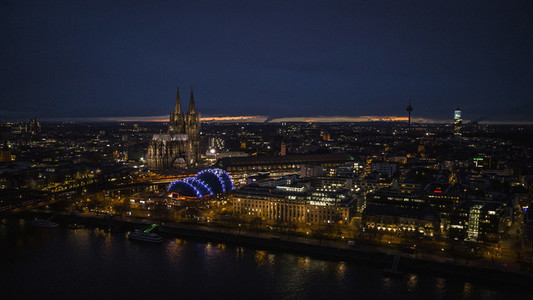 Illuminated Cologne Cathedral and cityscape at night