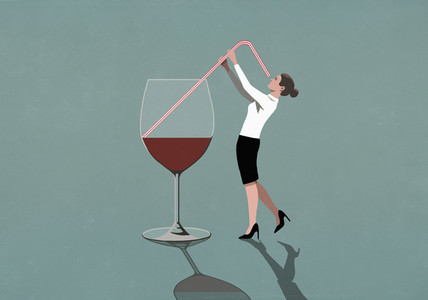 Businesswoman drinking from large wine glass with straw