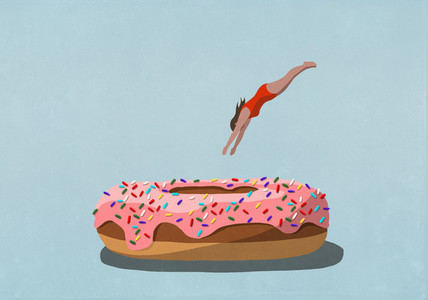 Woman diving into large sprinkled donut