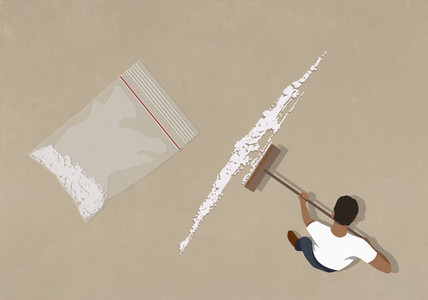 Man sweeping up cocaine with broom
