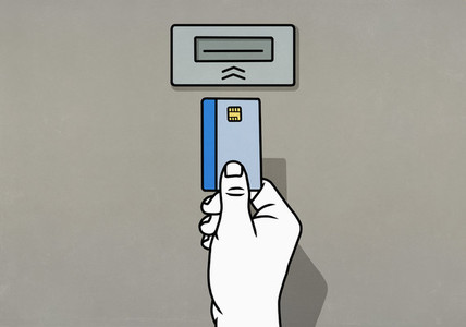 Hand inserting chip credit card into ATM