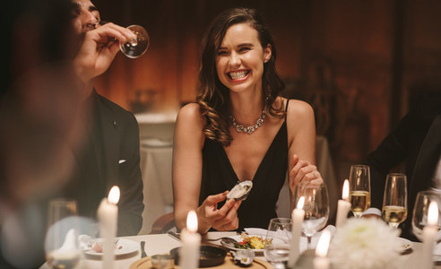 Pretty woman enjoying dinner party with friends