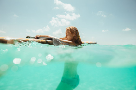Woman enjoying surfing in the sea