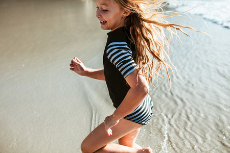 Girl running in water at the beach