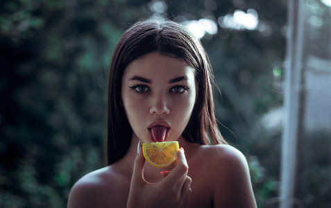 Fashion girl tongue touch to lemone