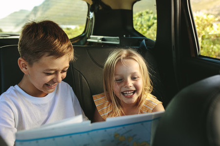 Kids  playing with map in car
