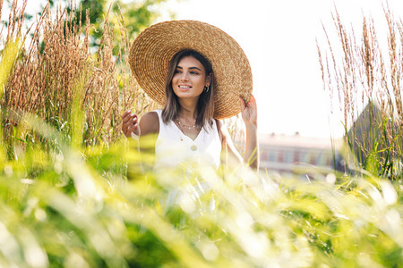 Young happy woman in big hat