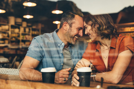 Loving couple enjoying date at cafe