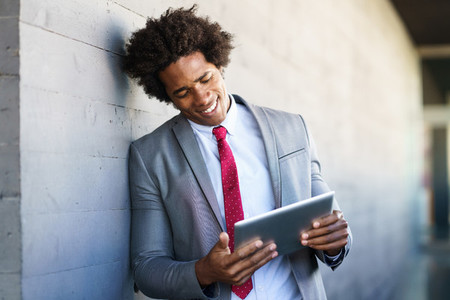 Black Businessman using a digital tablet in urban background