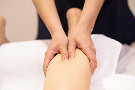 Medical massage at the leg in a physiotherapy center
