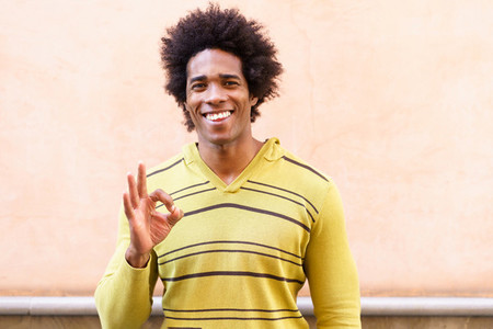 Black man with afro hair putting a funny expression