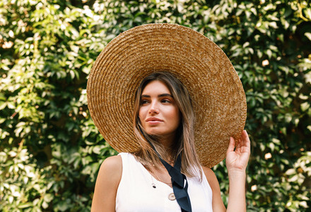 Young woman wearing a straw hat