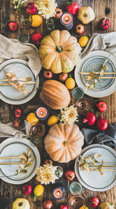 Table setting for Thanksgiving day party with fruits and candles